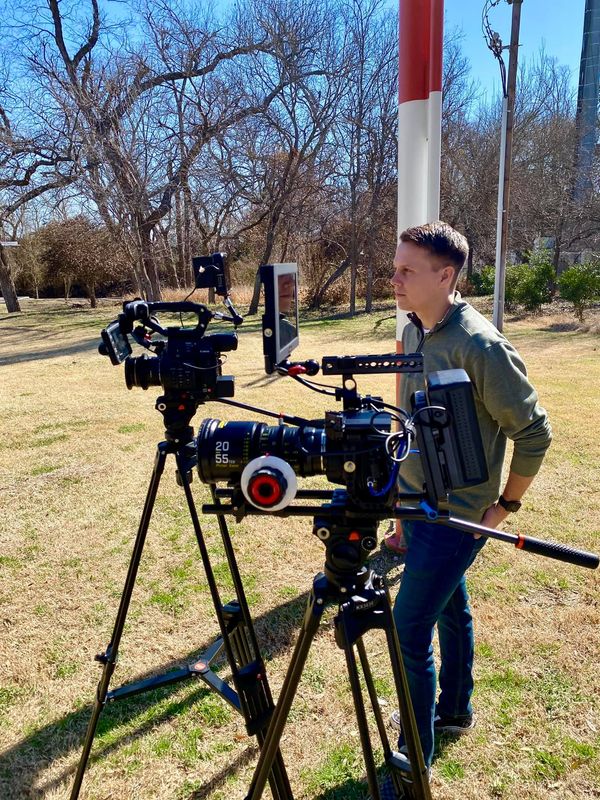 Wesley Blalock with cinema camera on tripod for an outdoor shoot